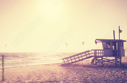 Vintage toned picture of lifeguard tower at sunset, Malibu.