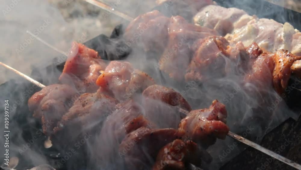 Doing Barbecue Over Hot Coals. Meat on skewers roasted over the coals. Delicious meat prepared on a spit over hot coals. Kitchen outdoors
Doing Barbecue Over Hot Coals. Meat on skewers roasted over the coals. Delicious meat prepared on a spit over hot coals. Kitchen outdoors