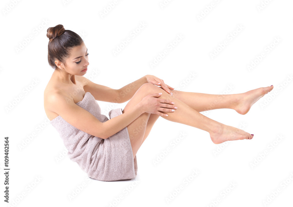 Beautiful young girl wrapped in a towel, isolated on white Beautiful young girl wrapped in a towel, isolated on white
