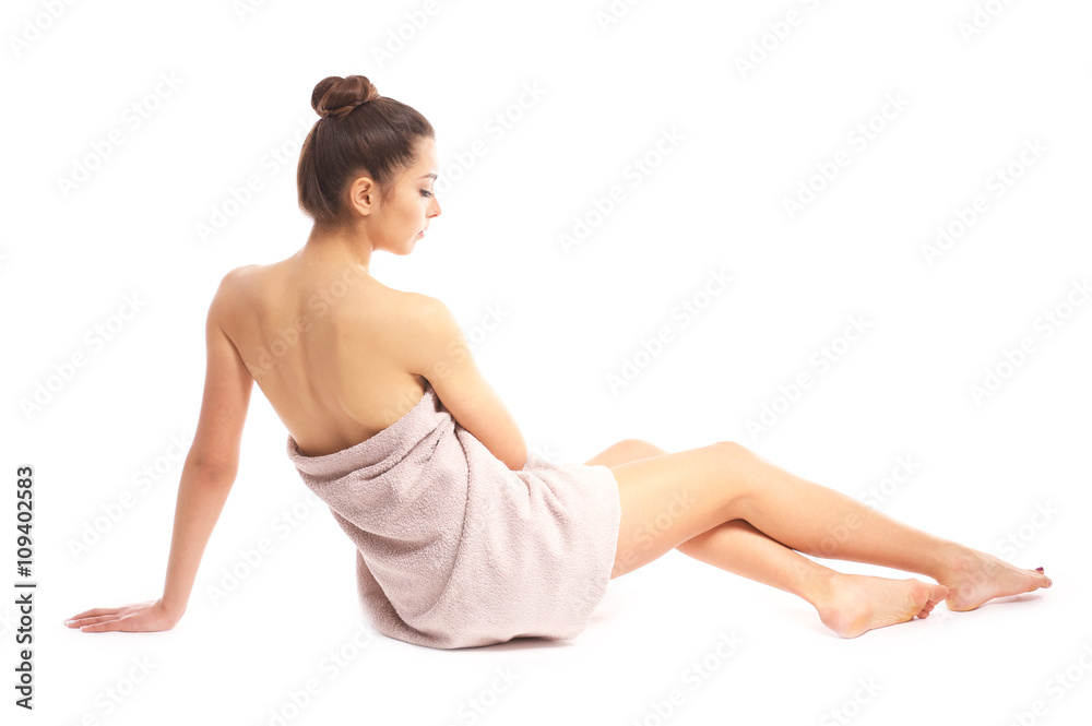 Beautiful young girl wrapped in a towel, isolated on white Beautiful young girl wrapped in a towel, isolated on white