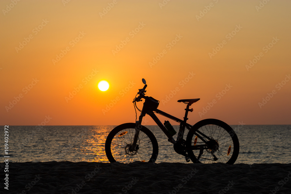 Mountain bike on the beach and sunset Mountain bike on the beach and sunset