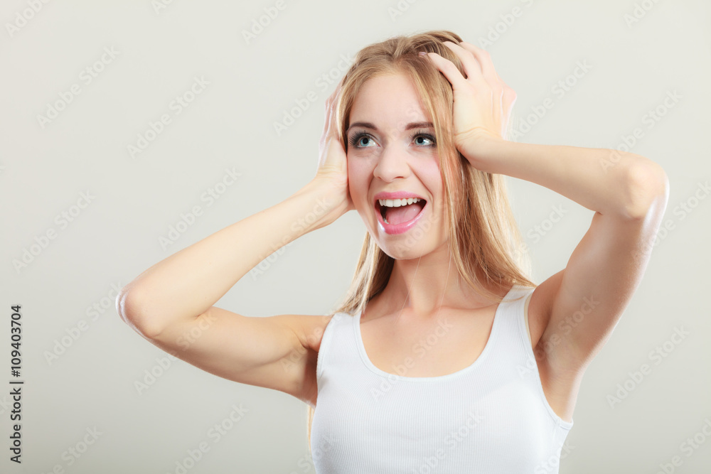 Closeup stressed woman covers ears with hands