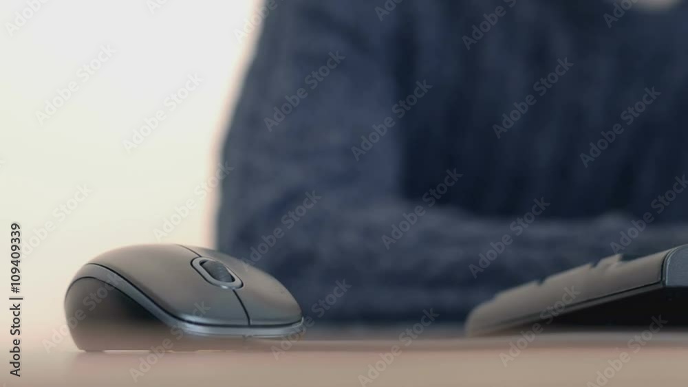 Hand of a man working at computer clicking on mouse typing text on keyboard Hand of a man working at computer clicking on mouse typing text on keyboard