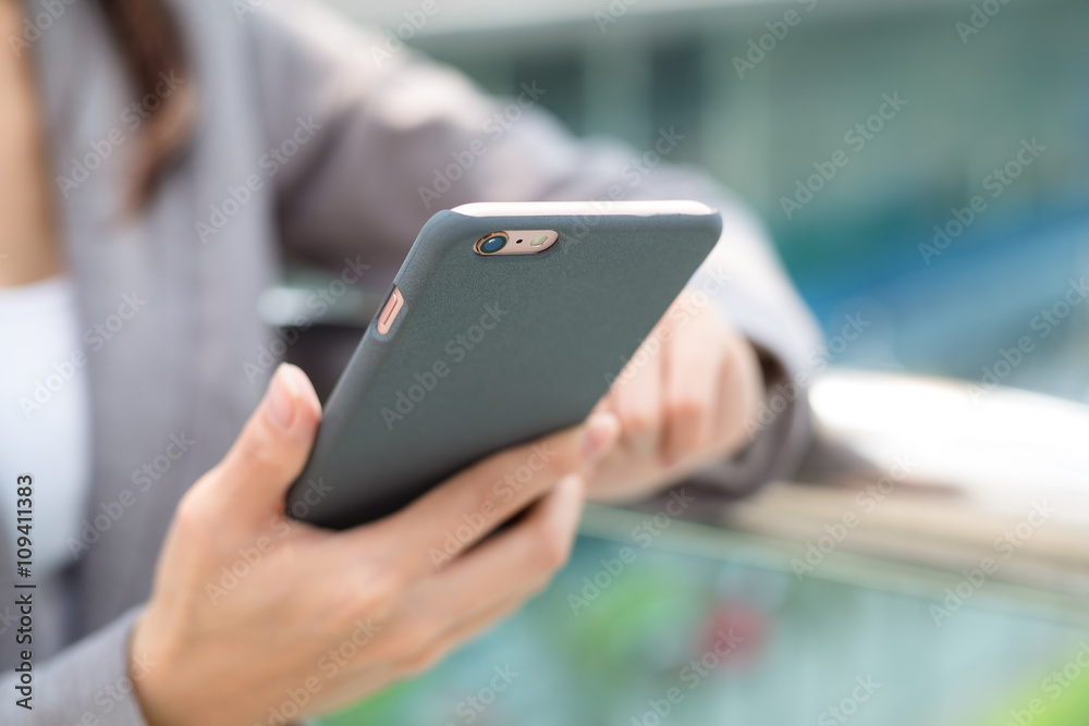 Businesswoman sending text message on cellphone Businesswoman sending text message on cellphone