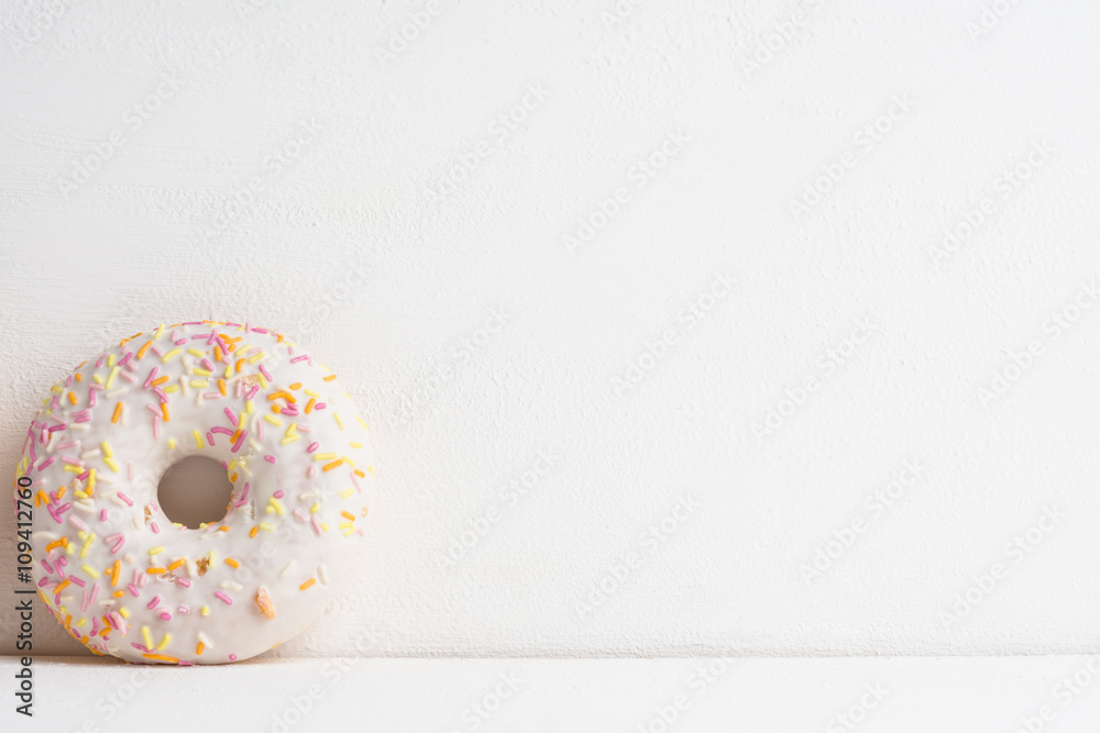 Donut with sprinkles on the white background