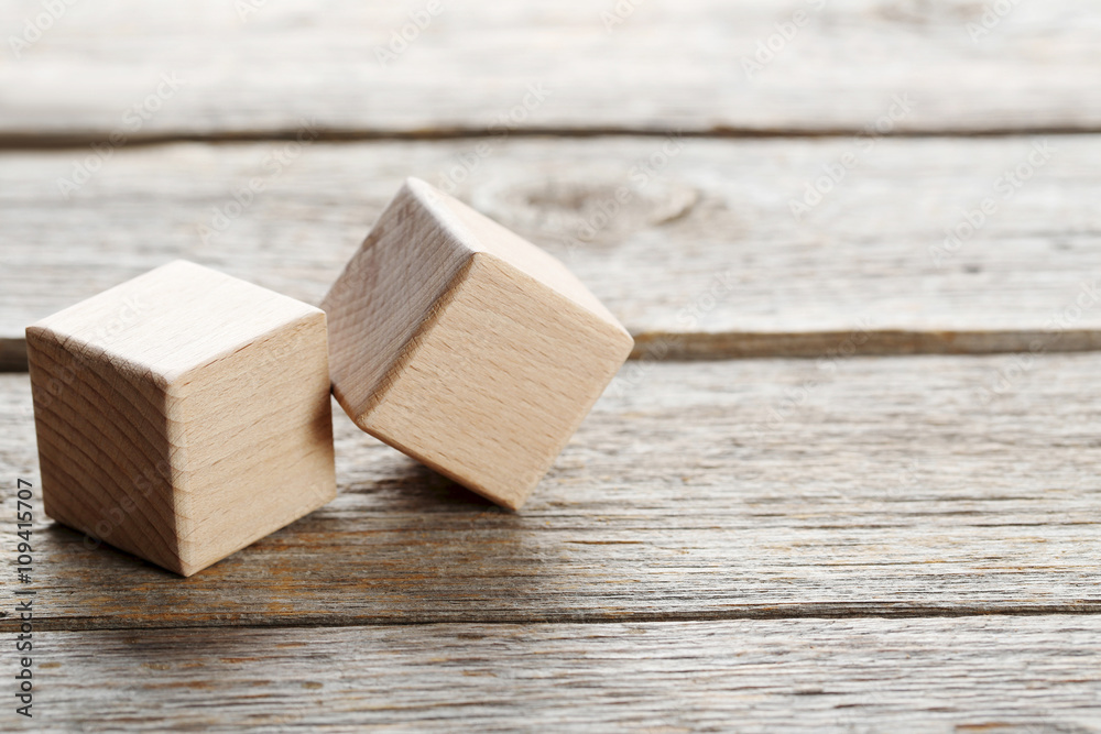 Wooden toy cubes on a grey wooden table