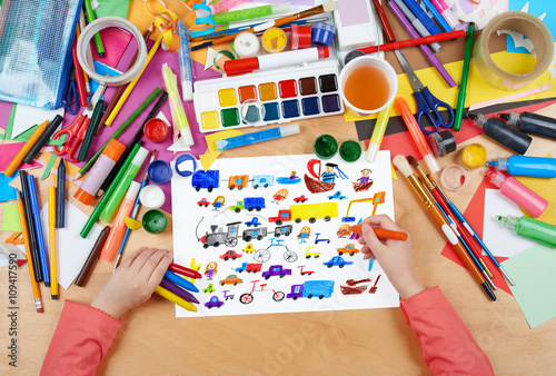 cartoon game toy and people collection child drawing , top view hands with pencil painting picture on paper, artwork workplace