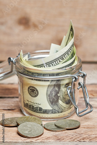 Glass jar with dollar bills