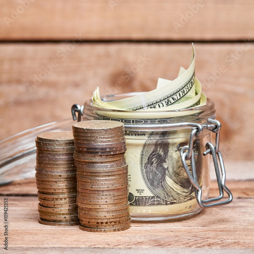 Glass jar with dollar bills