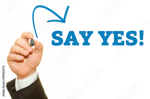 Businessman hand writing SAY YES message.