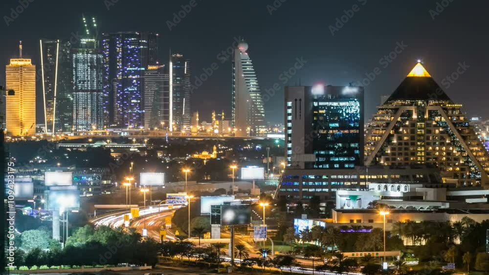 Scenic Dubai downtown skyline timelapse at night. Rooftop view of Sheikh Zayed road with numerous illuminated towers.