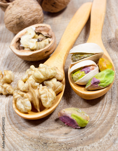 Closeup of a walnut and pistachios.