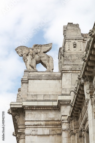  Facade and marble decorative statue at the central railway station in Milan, Italy