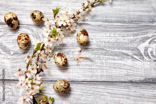 Spring easter composition with eggs and flowers on a gray old wooden background 