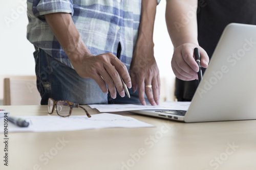 men working with business document and computer notebook