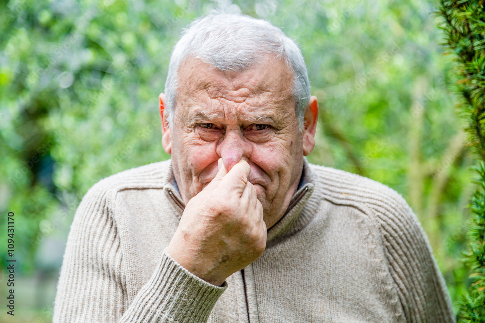 Elderly Caucasian in green garden Elderly Caucasian in green garden