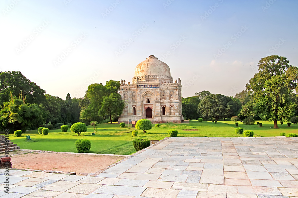 Lodi Gardens on the sunset. Islamic Tomb (Seesh Gumbad) set in landscaped gardens. 15th Century AD. New Delhi, India