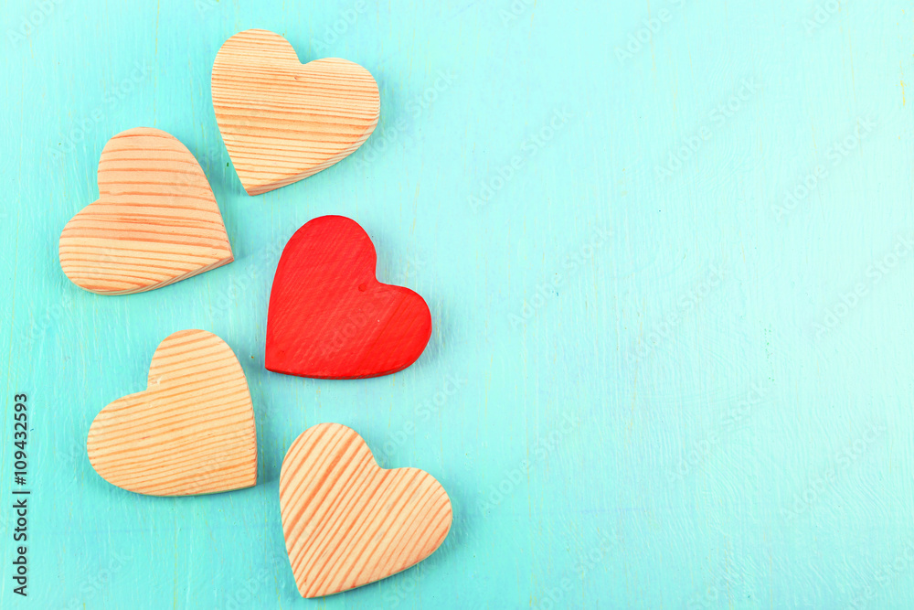 Obraz premium Wooden hearts on color wooden background