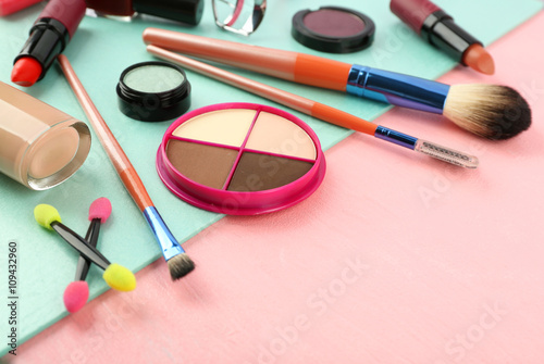 Makeup set with brushes and cosmetics on bright background