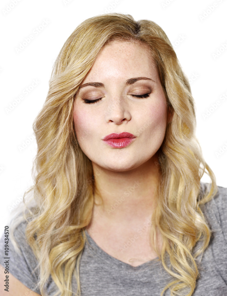 Beautiful blond woman with kissing lips. Positive Emotions. Young woman with copy space, isolated on white background. Beautiful blond woman with kissing lips. Positive Emotions. Young woman with copy space, isolated on white background.
