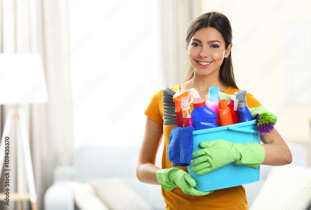 Beautiful woman with bucket of cleaning supplies Beautiful woman with bucket of cleaning supplies