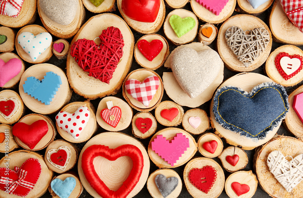 Set of different craft hearts on wooden logs Set of different craft hearts on wooden logs