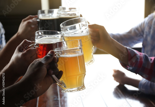 Friends drinking beer in pub