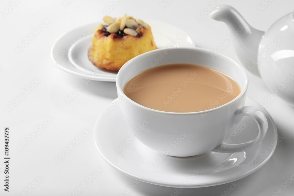 Milk tea with tea pot and a dessert on white background