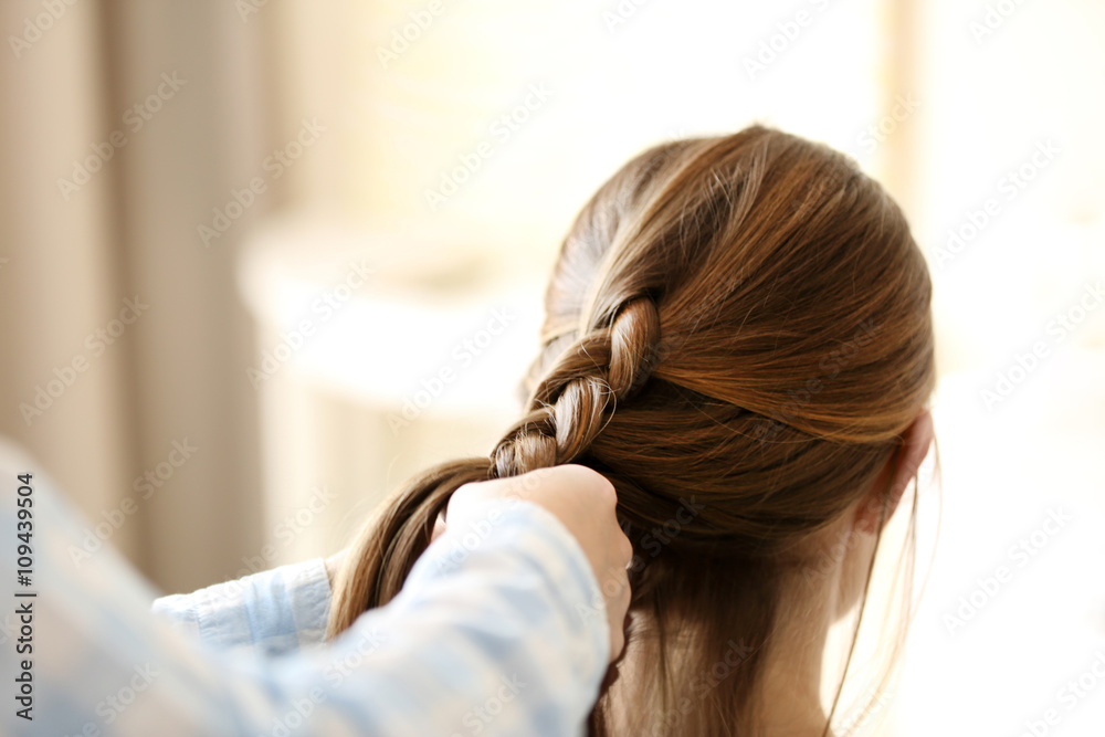 Fototapeta premium Woman making braids