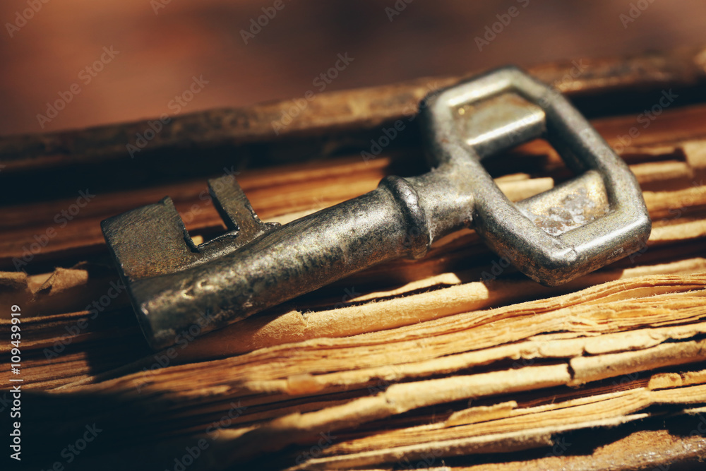 Key on old book, close up Key on old book, close up
