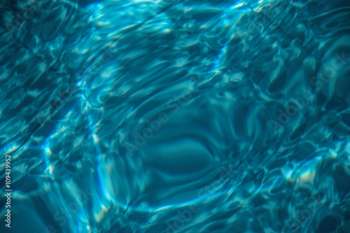 Ripple of water in the pool with sunny reflections, summer time, water waves