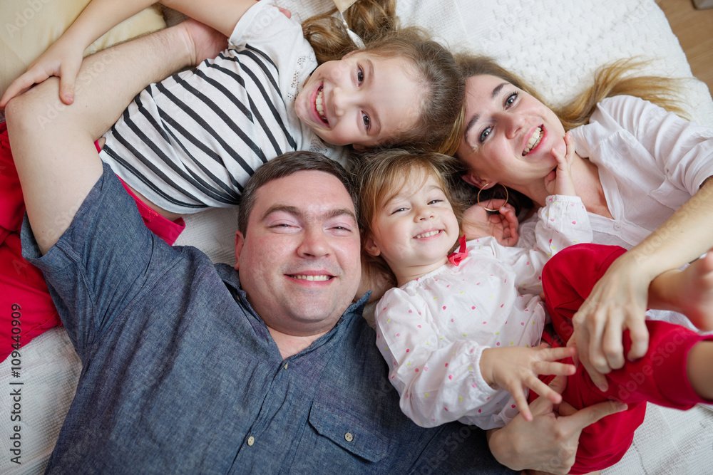 happy young family lying in bed