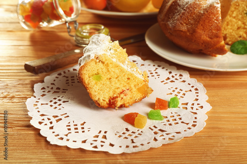 Piece of delicious citrus cake on wooden table