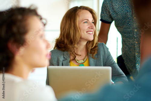 Candid image of a group with succesful business people caught in an animated brainstorming meeting
