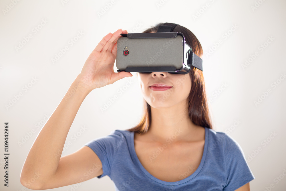 Woman wearing virtual reality goggles watching movies