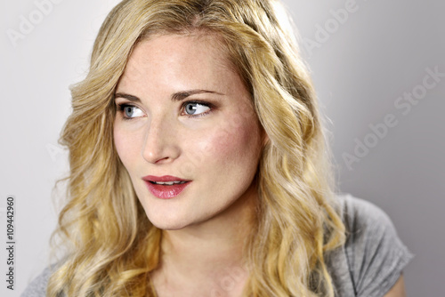 Beautiful blond woman. Portrait of a young woman, low key shot.