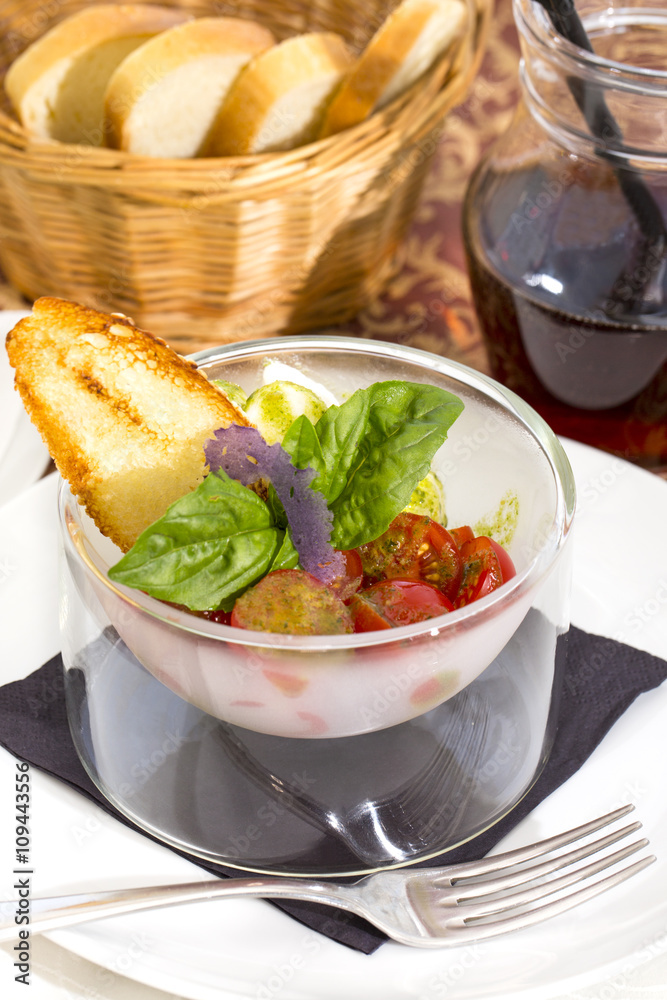 tomatoes and cheese on white plate in a restaurant tomatoes and cheese on white plate in a restaurant