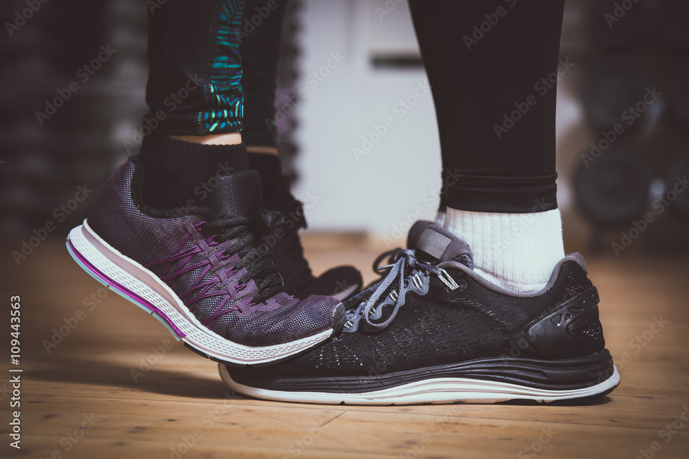 Closeup of sneakers. Girl standing on toes to kiss boyfriend. Couple  workout concept. Love sports concept. Stock Photo | Adobe Stock