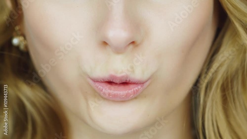 The lips of a young woman pronounce the English words - English Phonetics. To count from one to ten English photo