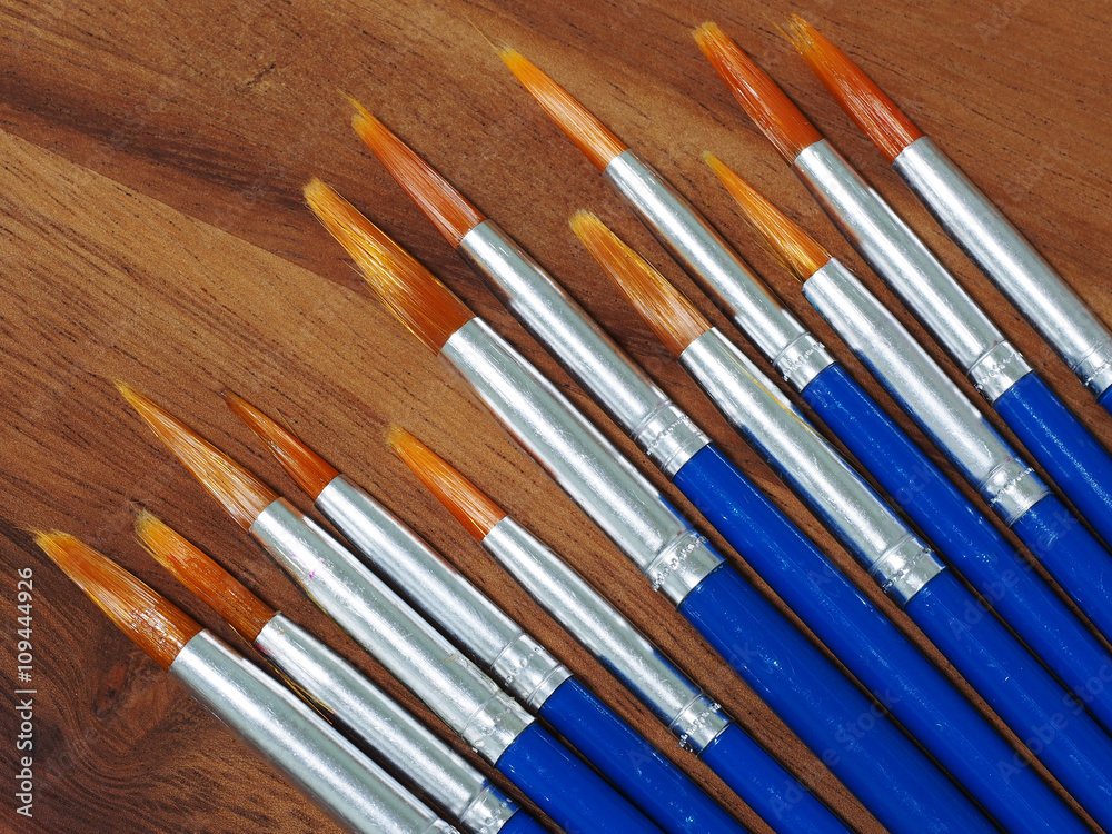 Fototapeta premium paintbrush on wooden background