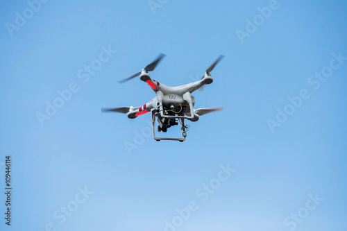 flying drone with professional cinema camera on the sky © subinpumsom