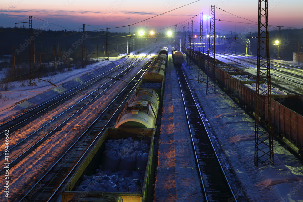 Top view of freight train with carriages on railways at winter 