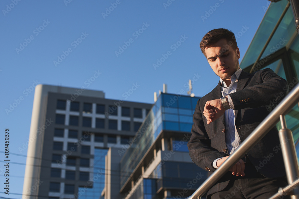 Businessman look at the hand with the watch Businessman look at the hand with the watch