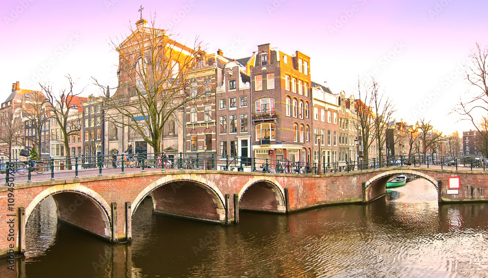 View of the canals with bridge and typical Dutch houses in Amsterdam, Netherlands