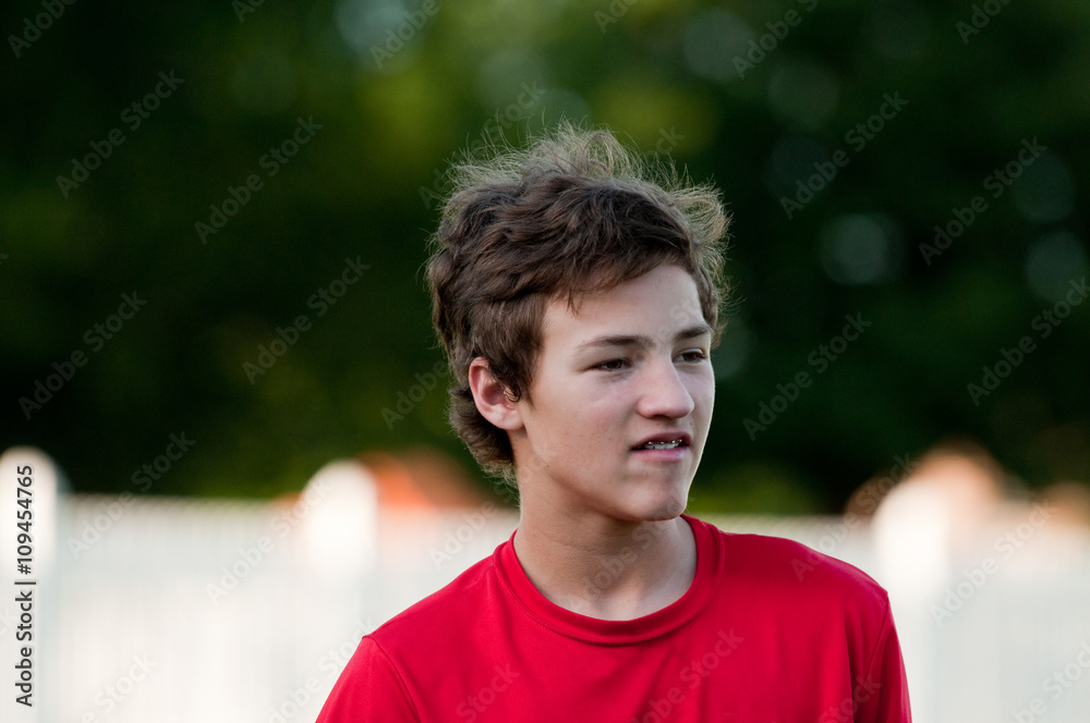 Handsome teenage boy outdoors with braces and messy hair. Handsome teenage boy outdoors with braces and messy hair.