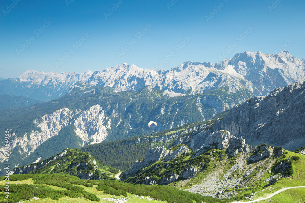 Alps mountains aerial view with paraglider over Alpine landscape