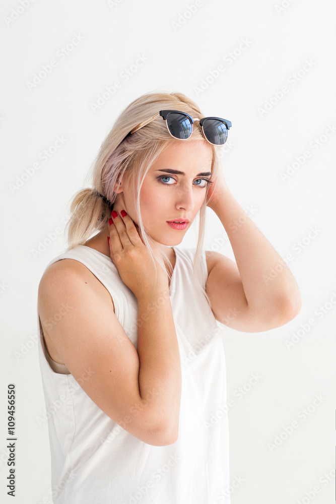 Fashion confident model in sunglasses. Beautiful young woman with sunglasses  on head. Concept for advertisement, flyer, banner. Beautiful sexy girl in  glasses looking at the camera Stock Photo | Adobe Stock