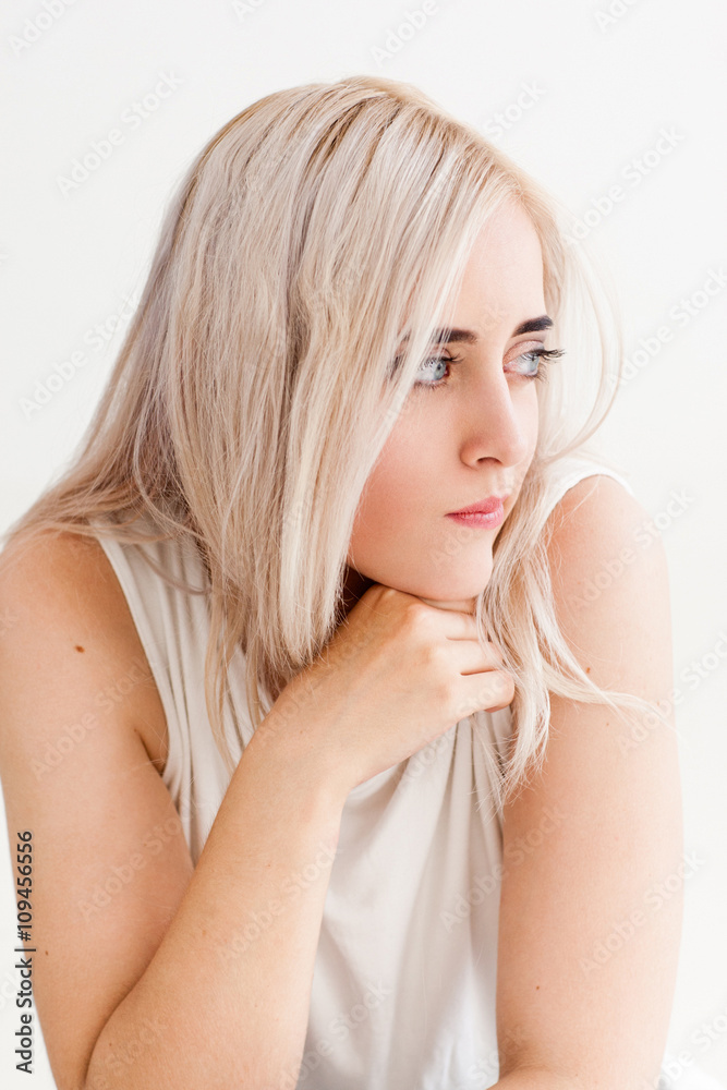 Sad envy woman on the white background. Yearning disappointed lonely woman looking to the left. The concept of misunderstanding, loneliness, jealousy. Sad envy woman on the white background. Yearning disappointed lonely woman looking to the left. The concept of misunderstanding, loneliness, jealousy.