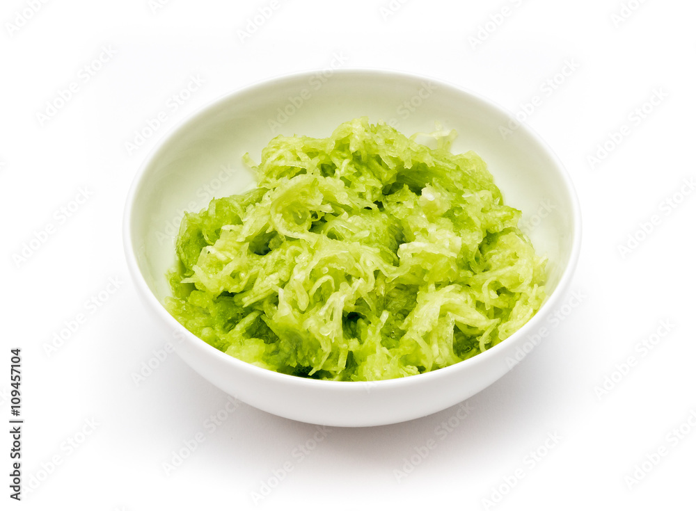 Grated cucumber in white dish, isolated on white background. Grated cucumber in white dish, isolated on white background.