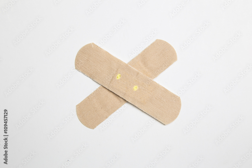 Close up shot of a bandaid against isolated white background. Close up shot of a bandaid against isolated white background.